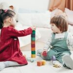 Small children stacking building blocks