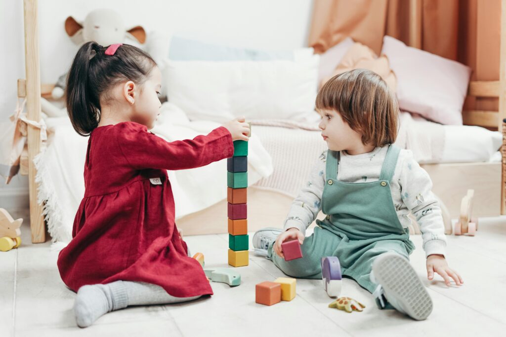 Small children stacking building blocks