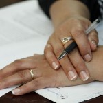 Woman's hands holding a pen